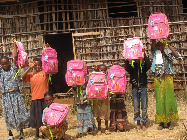 A group of people holding school bags

Description automatically generated